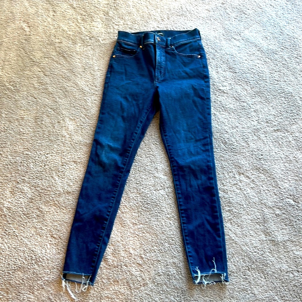 Skinny , raw hem step up dark wash jeans .